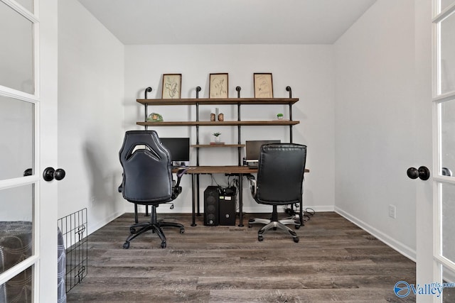 office space with baseboards and wood finished floors