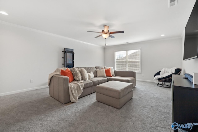 carpeted living room featuring baseboards, visible vents, a ceiling fan, and ornamental molding