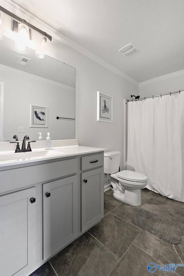 bathroom with ornamental molding, vanity, and toilet