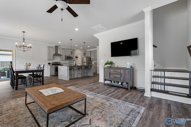 living area featuring crown molding, visible vents, dark wood-style flooring, and recessed lighting