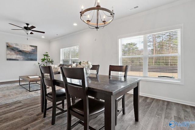 dining area with visible vents, wood finished floors, and ornamental molding