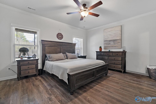 bedroom featuring dark wood-style floors, multiple windows, visible vents, and crown molding