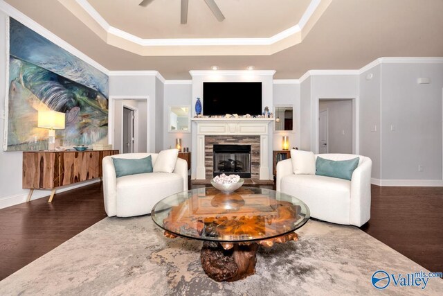 2906 Pasture View Ln, Owens Cross Roads, AL 35763 - living room with a tray ceiling, wood finished floors, a fireplace, ceiling fan, and crown molding