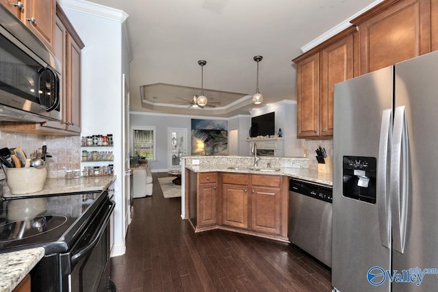 2906 Pasture View Ln, Owens Cross Roads, AL 35763 - kitchen with stainless steel appliances, brown cabinetry, a peninsula, dark wood-type flooring, and crown molding