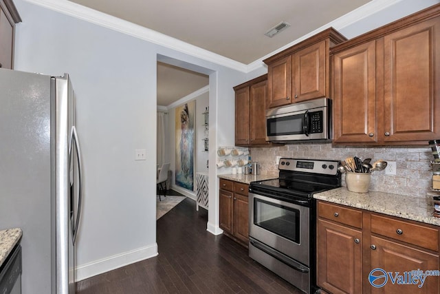 2906 Pasture View Ln, Owens Cross Roads, AL 35763 - kitchen with appliances with stainless steel finishes, decorative backsplash, dark wood-style floors, light stone counters, and ornamental molding
