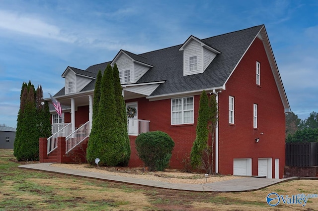 12956 Hickory Hills Rd, Athens, AL 35614 - cape cod-style house with a porch and a garage