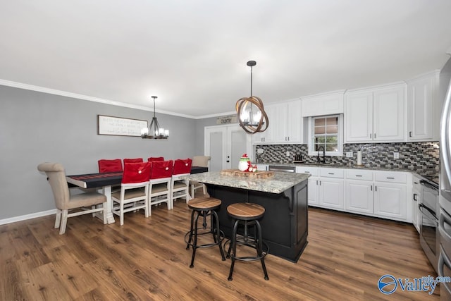 12956 Hickory Hills Rd, Athens, AL 35614 - kitchen with white cabinetry, dark hardwood / wood-style flooring, a kitchen island, and light stone counters
