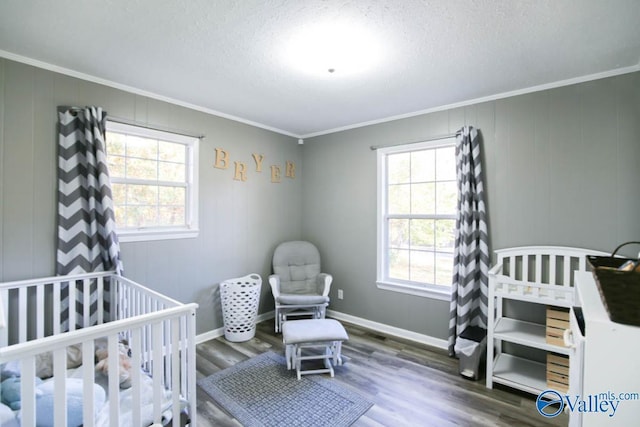 bedroom featuring ornamental molding, dark hardwood / wood-style floors, and a textured ceiling