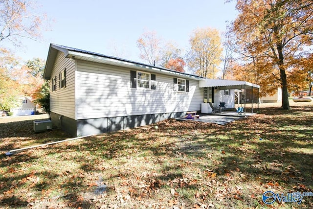 back of property featuring a yard and a patio area