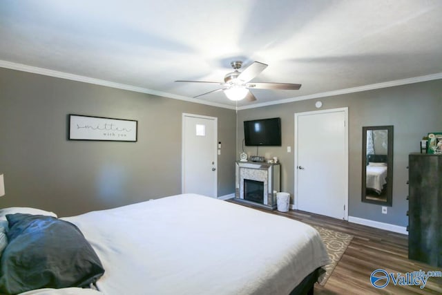 bedroom featuring ornamental molding, dark hardwood / wood-style floors, and ceiling fan