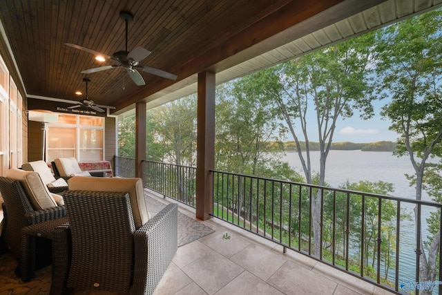 sunroom / solarium with wooden ceiling, a water view, and ceiling fan