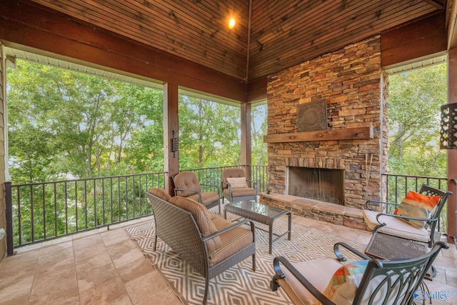 view of patio with an outdoor living space with a fireplace