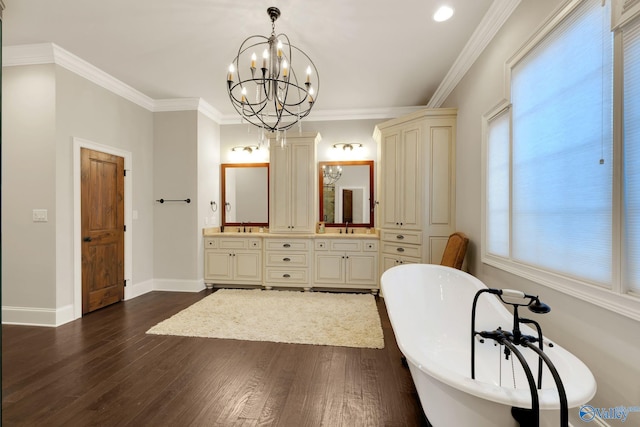 bathroom featuring a bathing tub, vanity, crown molding, hardwood / wood-style flooring, and an inviting chandelier