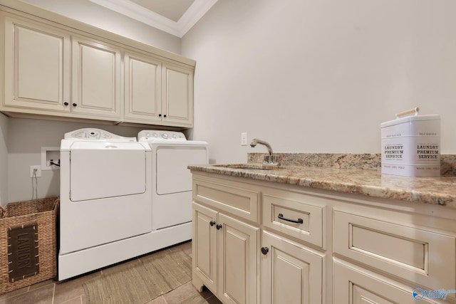 laundry room with cabinets, ornamental molding, sink, and washer and clothes dryer