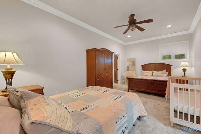 carpeted bedroom with ornamental molding and ceiling fan