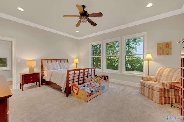 carpeted bedroom with ornamental molding and ceiling fan