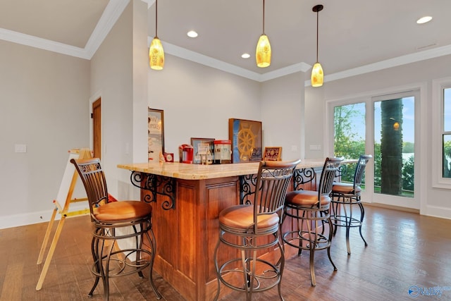 bar featuring ornamental molding, decorative light fixtures, and dark hardwood / wood-style flooring