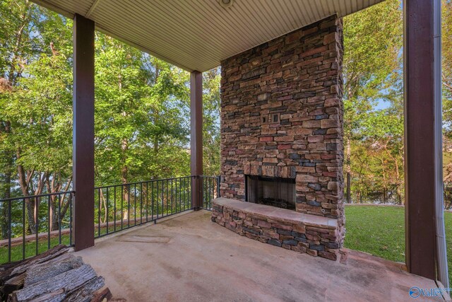 view of patio with an outdoor stone fireplace