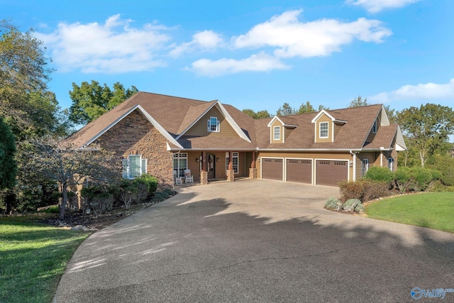 craftsman inspired home featuring a front lawn and a garage