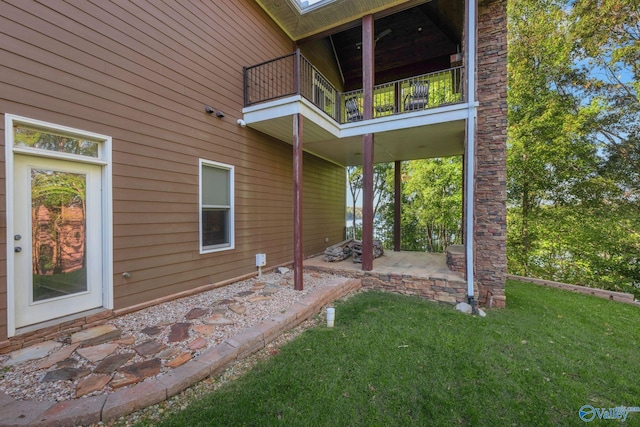 exterior space featuring a patio area, a yard, and a balcony