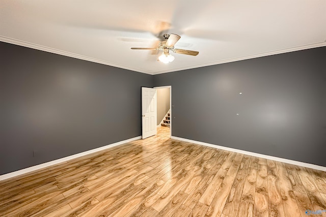 1509 Southampton Ct, Decatur, AL 35601 - spare room featuring a ceiling fan, ornamental molding, wood finished floors, and baseboards