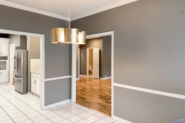 1509 Southampton Ct, Decatur, AL 35601 - unfurnished dining area with ornamental molding, light tile patterned floors, and baseboards