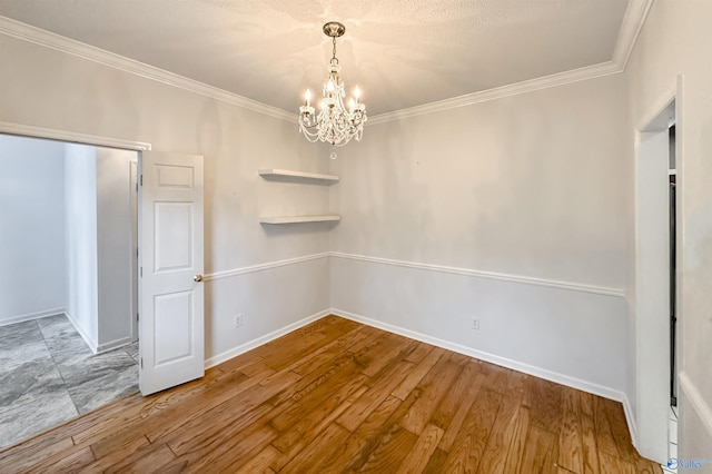 1509 Southampton Ct, Decatur, AL 35601 - unfurnished dining area featuring a chandelier, ornamental molding, baseboards, and wood finished floors
