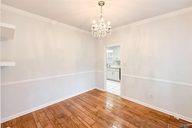 1509 Southampton Ct, Decatur, AL 35601 - empty room featuring a chandelier, light wood-style floors, ornamental molding, and baseboards