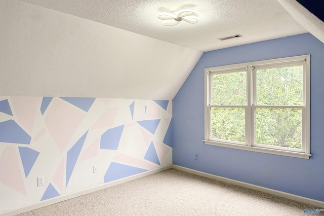 1509 Southampton Ct, Decatur, AL 35601 - additional living space with healthy amount of natural light, vaulted ceiling, a textured ceiling, carpet flooring, and baseboards