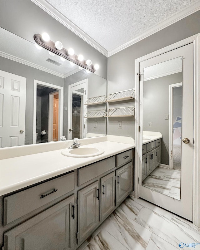 1509 Southampton Ct, Decatur, AL 35601 - full bathroom featuring marble look tile flooring, vanity, ornamental molding, toilet, and a textured ceiling