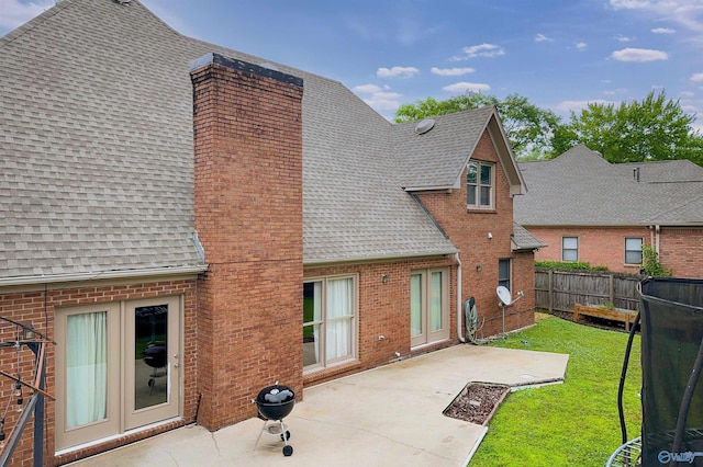 1509 Southampton Ct, Decatur, AL 35601 - rear view of property with roof with shingles, a chimney, brick siding, and a patio