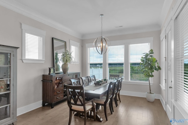241 Farmhouse Dr, Madison, AL 35757 - dining space featuring a chandelier, baseboards, light wood-type flooring, and crown molding
