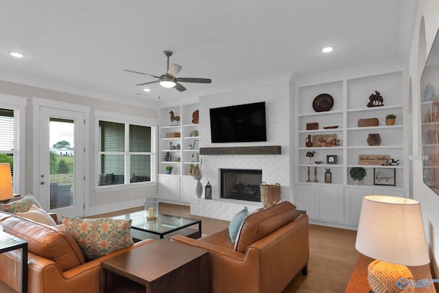 241 Farmhouse Dr, Madison, AL 35757 - living room with wood finished floors, ceiling fan, built in features, recessed lighting, and a brick fireplace