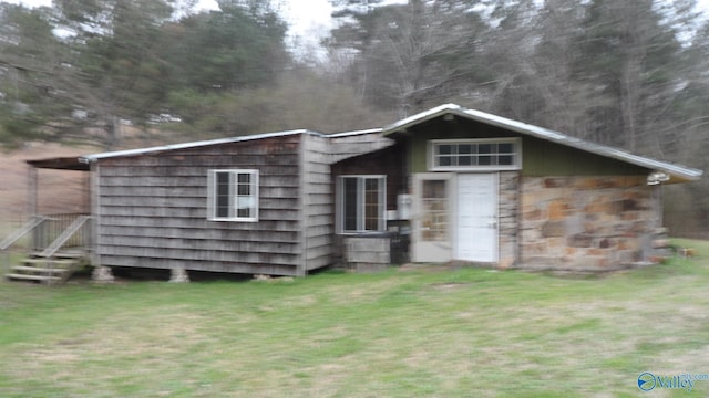 rear view of property featuring a yard