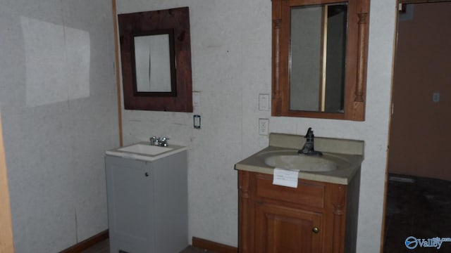 full bathroom with two vanities and a sink