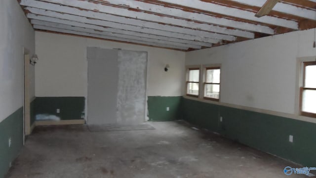 unfurnished room featuring concrete floors