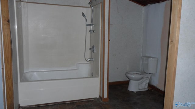 bathroom featuring tub / shower combination and toilet