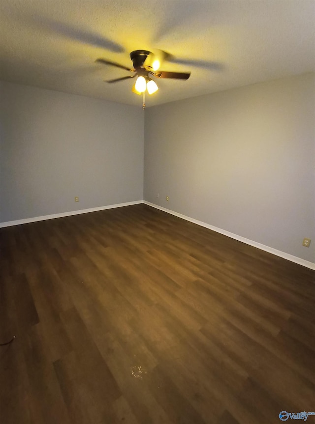 unfurnished room with dark wood-type flooring, a textured ceiling, and ceiling fan