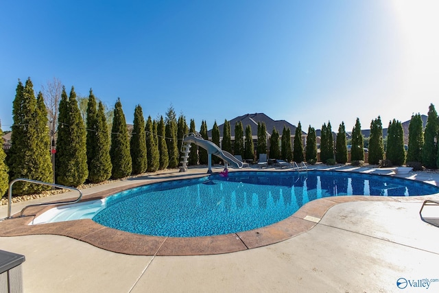 108 NW Rockhaven Dr, Madison, AL 35757 - swimming pool with a water slide, a patio, and a diving board