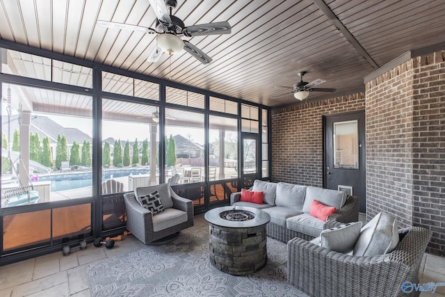 108 NW Rockhaven Dr, Madison, AL 35757 - sunroom / solarium featuring ceiling fan and an outdoor living space with a fire pit