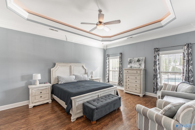 108 NW Rockhaven Dr, Madison, AL 35757 - bedroom featuring a raised ceiling, ornamental molding, multiple windows, and dark wood finished floors