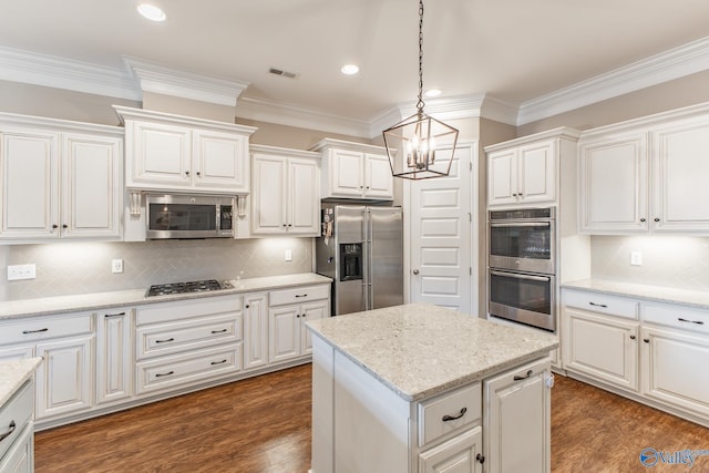 108 NW Rockhaven Dr, Madison, AL 35757 - kitchen featuring stainless steel appliances, ornamental molding, a chandelier, white cabinets, and backsplash