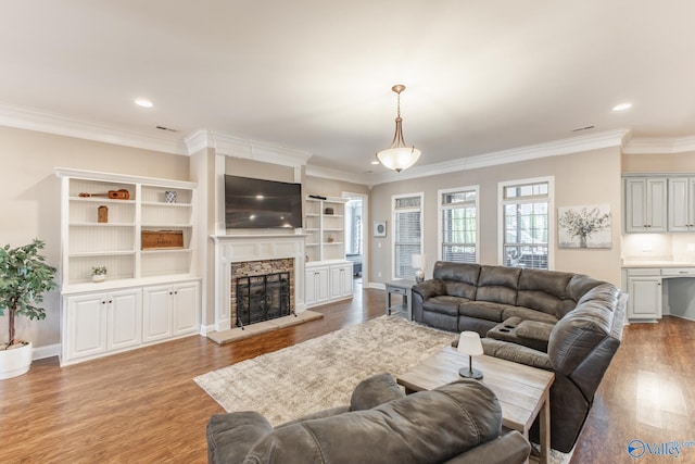 108 NW Rockhaven Dr, Madison, AL 35757 - living room featuring wood finished floors, a fireplace, crown molding, recessed lighting, and baseboards