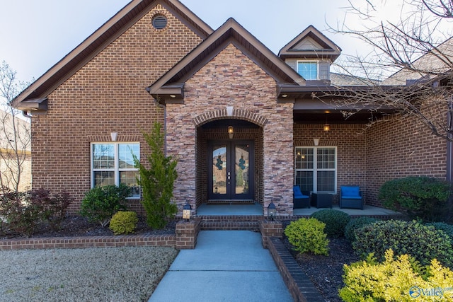108 NW Rockhaven Dr, Madison, AL 35757 - doorway to property featuring french doors, brick siding, and stone siding
