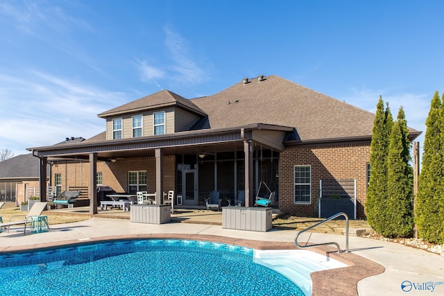 108 NW Rockhaven Dr, Madison, AL 35757 - rear view of house featuring brick siding, a ceiling fan, a patio area, an outdoor pool, and a shingled roof