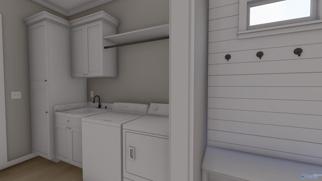 washroom featuring cabinets, sink, light hardwood / wood-style flooring, washing machine and dryer, and ornamental molding