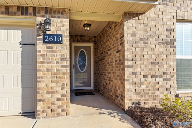 view of exterior entry with brick siding