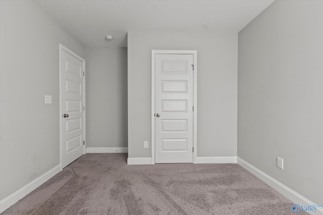 unfurnished bedroom featuring baseboards and carpet