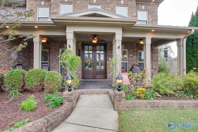 view of exterior entry featuring french doors and covered porch