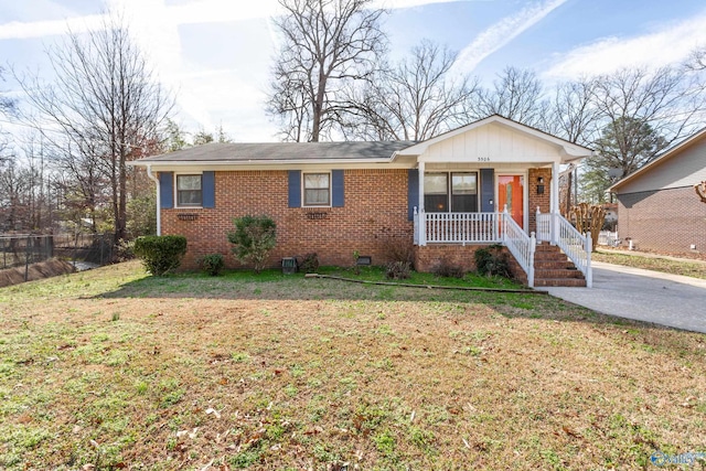 view of front of house with a front yard and a porch